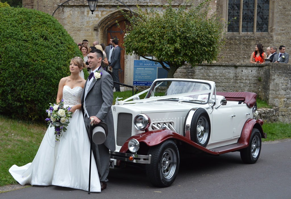 Natasha and Dean with their wedding car at purton church