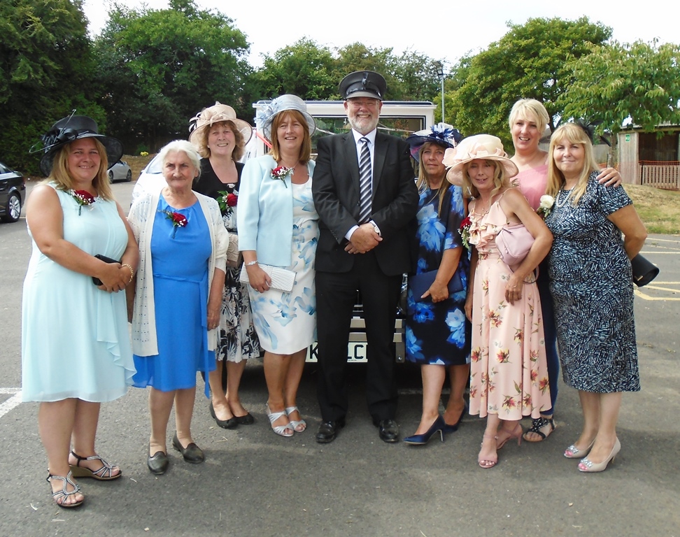 Mother of bride and guests with chauffeur and wedding car